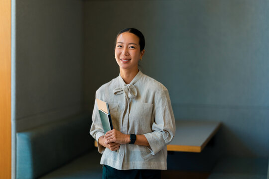 Portrait of a  Businesswoman Holding Folder in Office