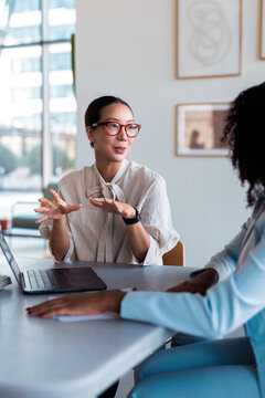 Business Meeting Between Female Colleagues Discussing Strategy