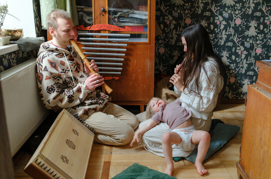 Family relaxing and playing music at home
