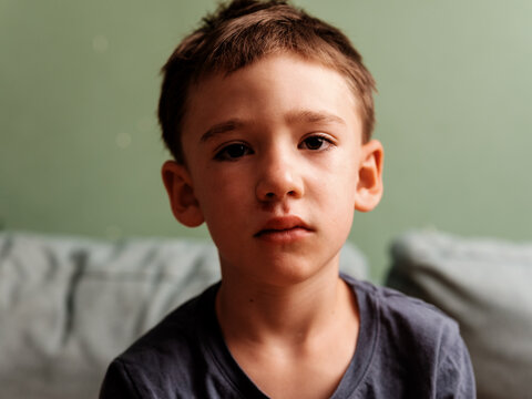 Injured Sad Boy with Scratched Face and Swollen Lip Portrait