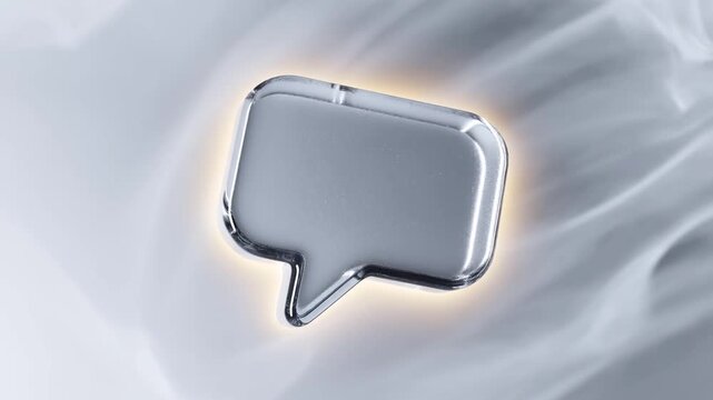 Reflective speech bubble icon rotating against a softly illuminated white background