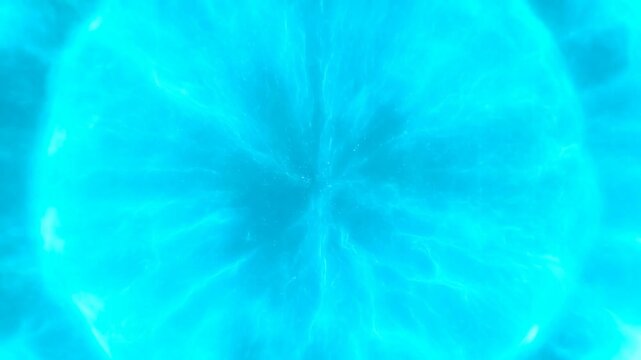 Luminous turquoise energy sphere expands with radiating filaments against a dark blue background