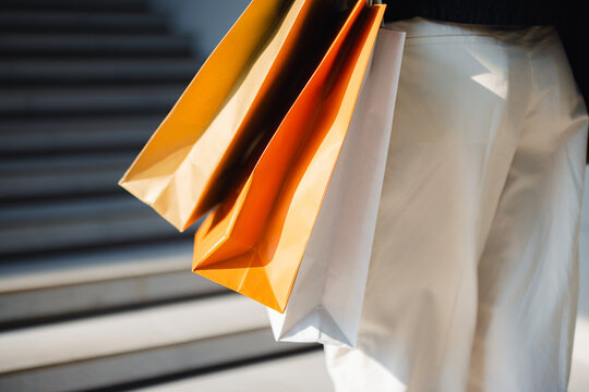 Shopping Bags Held by a Person Near Outdoor Steps