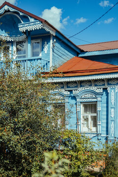 Old wooden house with decorative elements in a garden setting