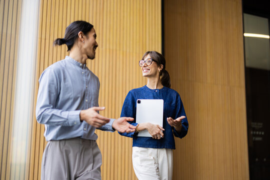 Colleagues Talking in a Modern Building Hallway