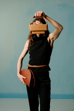 Minimal Fashion Model Holding Leather Handbag