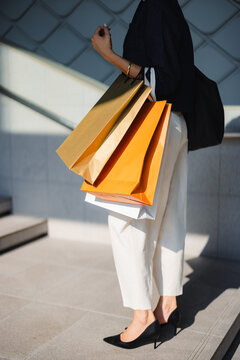 Shopping Bags Held by a Woman