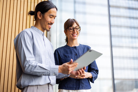 Colleagues Discussing Plans in a Modern Office Setting