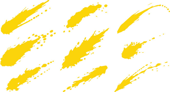 Nine yellow paint brush strokes and splatters isolated on a white background