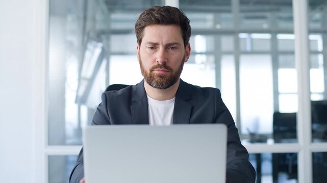 Pensive worried Caucasian middle-aged business man entrepreneur professional thinking looking in laptop mature businessman pondering male think work with computer website difficulty solving in office