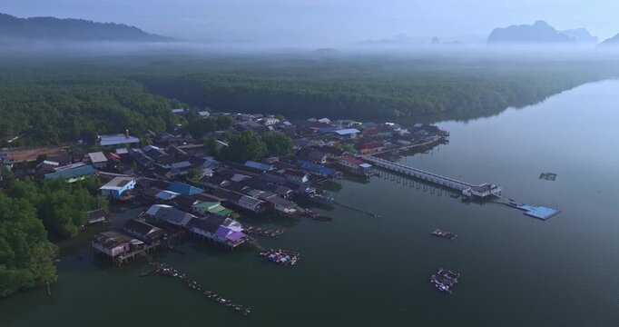 Baan Sam Chong fishing community in Phang Nga, Thailand, surrounded by mangrove forests and coastal waters, representing traditional livelihoods, local culture, tourism, and rural life.
