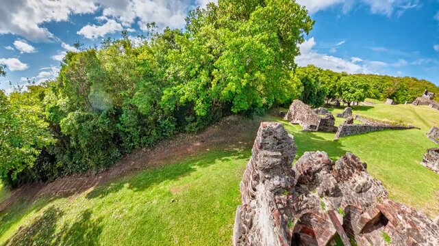 Chateau Dubuc. A historic colonial plantation on Caravelle Peninsula. Presents ancient stone ruins on a green hillside in Martinique. Showcasing the remains of its sugar and coffee production past