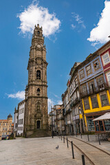 Obraz premium Famous Clerigos Tower rising above historic buildings in Porto city center, showcasing baroque architecture and urban landscape in northern Portugal.