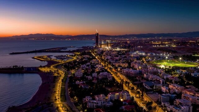 Aerial sunset to night hyperlapse view of the coast of Athens, Greece, with Glyfada district, yacht marinas, beaches and street traffic
