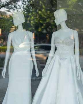 Elegant Wedding Dresses Displayed on Mannequins in Bridal Boutique Window