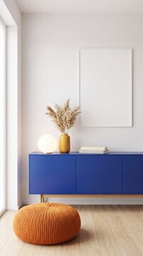 Living room wall with cobalt sideboard, orange knitted pouf, pampas grass and blank frame mockup
