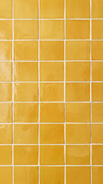 Handmade mustard yellow glazed tiles with white grout, warm ochre wall texture