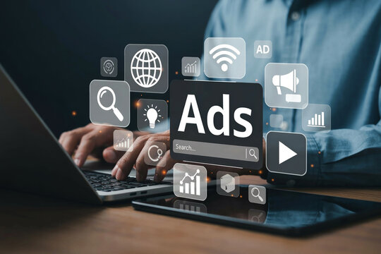 Digital marketer managing online ad campaigns search ads and social media promotion on laptop