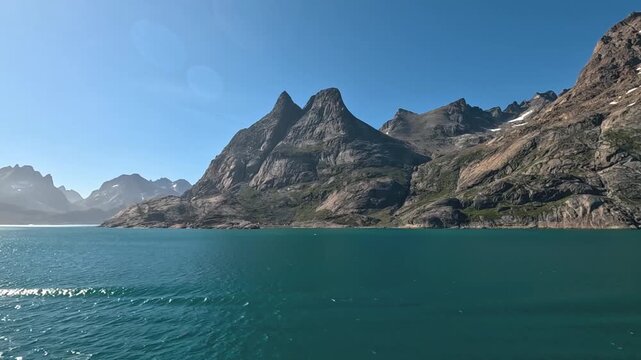 A HD smooth timelapse video around the rocky mountains at Prince Kristian Fjord in Greenland, in summer.