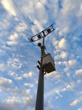 Street lamp post against blue sky.