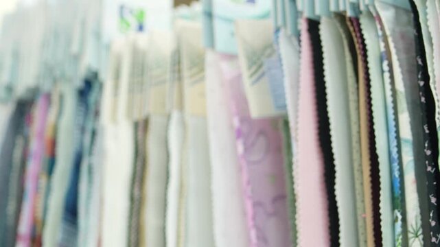Rows of Colorful Fabric Swatches Hanging in Catalog,Fabric Sample Library for Garment Manufacturing