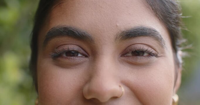 Camera starting recording, Indian woman holding gaze, blinking, squinting and smiling