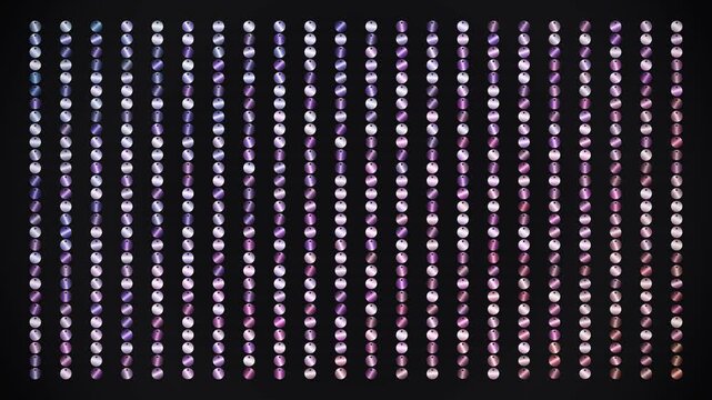 Sparkling purple and pink sequin background video featuring endless rows of shiny metallic discs moving gracefully across the dark screen for festive celebrations