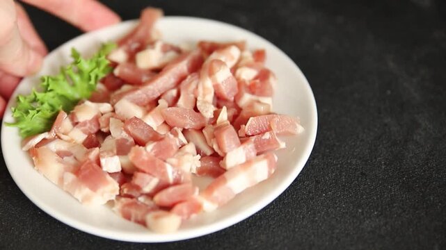 Bacon sliced into pieces pork meat lard serving size natural ingredients eating dish, tasty snack fresh, gourmet, rustic food background on the table top view copy space