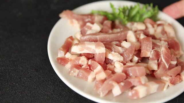 Bacon sliced into pieces pork meat lard serving size natural ingredients eating dish, tasty snack fresh, gourmet, rustic food background on the table top view copy space