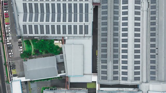 Aerial view of industrial facility with solar panels on the roof and a parking lot in Indonesia.