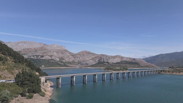 Aerial Landscape of Ria&ntilde;o Lake with Long Bridge, Mountain Peaks and Village in Le&oacute;n, Spain