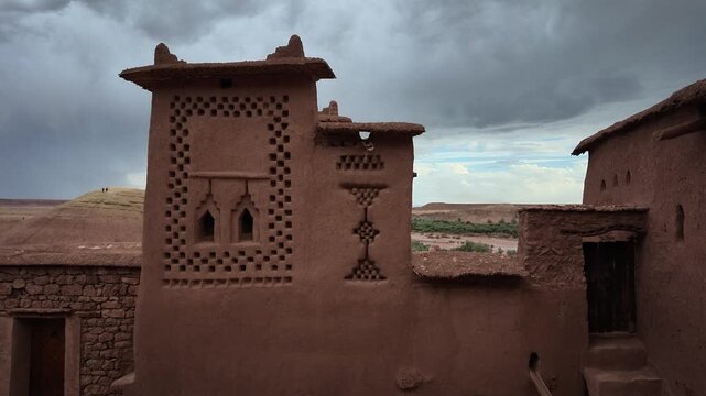 Close-up of traditional earthen mud-brick architecture and decorative geometric window details on an ancient fort tower at A&iuml;t Benhaddou in Morocco