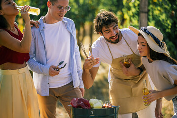 Naklejka premium Friends working together to prepare food during an outdoor vineyard event