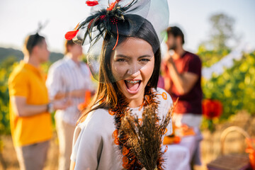 Naklejka premium Excited woman in Halloween costume holding a decorated broom outdoors