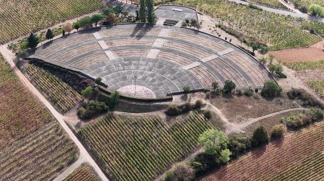 Aerial view of an amphitheater surrounded by lush vineyards in the countryside of Colmar, Grand Est, France.
