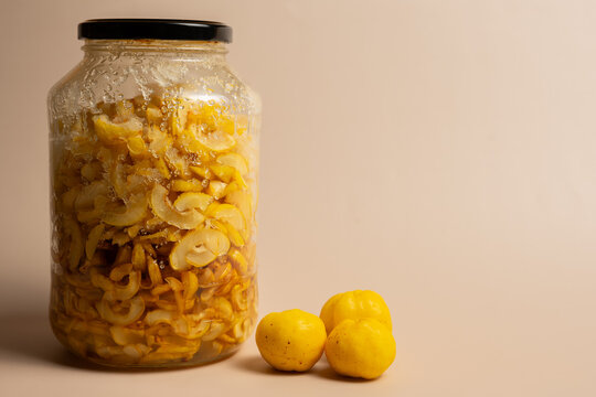 Fresh Quince and Homemade Preserved Quince Jar on Neutral Background
