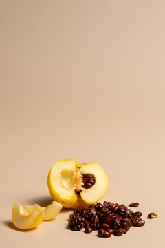 Quince with Seed Pile on Beige Background with Copy Space
