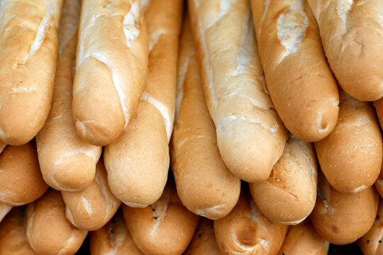 Close-up of soft white baguette loaves stacked in large quantities at a market. Siem Reap. Cambodia.