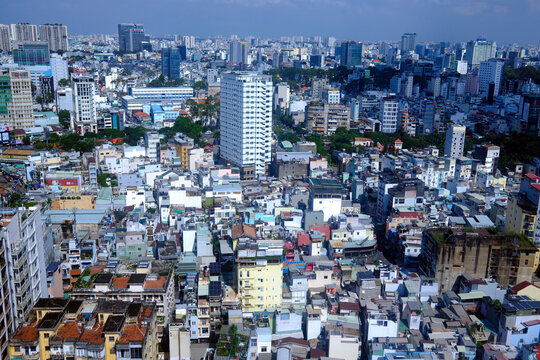 The vibrant cityscape of Ho Chi Minh City stands illuminated beneath a threatening monsoon sky. Ho Chi Minh city. Vietnam.