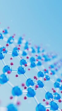Closeup of a 3D blue and red metallic molecular lattice. Moving atoms linked by bonds with shallow depth of field. Scientific, cosmetics or healthcare concept loop animation. Vertical Video.