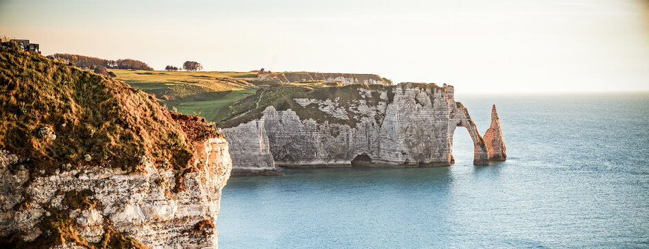coastal landscape along the Falaise d'Aval the famous white cliffs of Etretat village with the Porte d'Aval natural arch and the rock known as the Aiguille d'Etretat