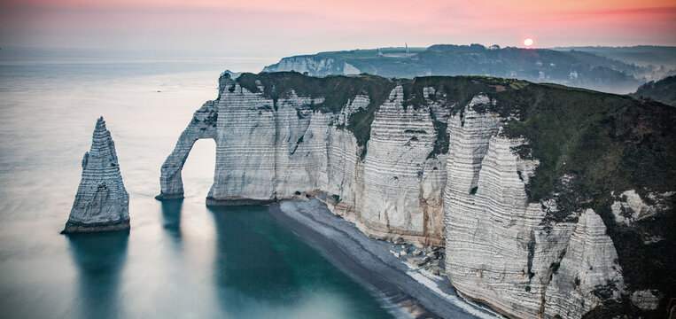 coastal landscape along the Falaise d'Aval the famous white cliffs of Etretat village with the Porte d'Aval natural arch and the rock known as the Aiguille d'Etretat