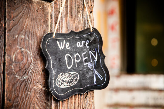 we are open sign on restaurant door