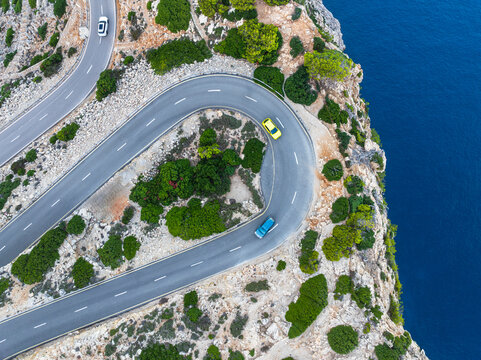 Cars traveling a hairpin bend along coastal road above the cliff, overhead view, Cap de Formentor, Sierra de Tramontana, Pollenca municipality, Majorca island, Balearic Islands, Spain, Mediterranean