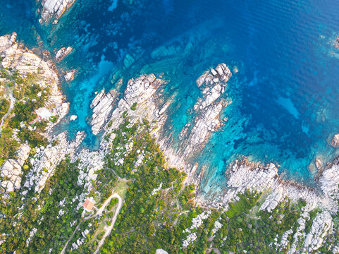 Top-down aerial view of rocky coast with granite rocks facing turquoise sea, Capo Testa, Santa Teresa di Gallura, Mediterranean Sea, Olbia-Tempio province, Sardinia, Italy