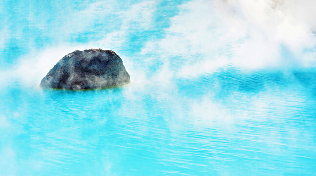 Mystical view of a rock shrouded in steam from the blue pond of Kamado Jigoku ('Furnace Hell'), Beppu, Oita, Kyushu, Japan