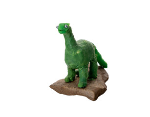 Handmade green plasticine dinosaur figurine on a stone base. DIY clay craft, child's art, long-necked toy with googly eyes, isolated. © Андрей Знаменский