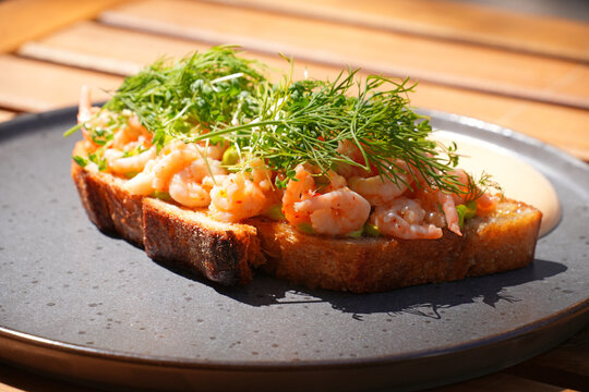 Traditional Scandinavian shrimp toast (toast Skagen) with dill, egg and mayonnaise