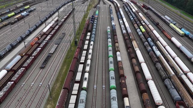 Aerial view of a massive railway freight yard filled with tanker wagons, cargo trains and parallel tracks, showcasing rail transportation, industrial logistics and infrastructure.