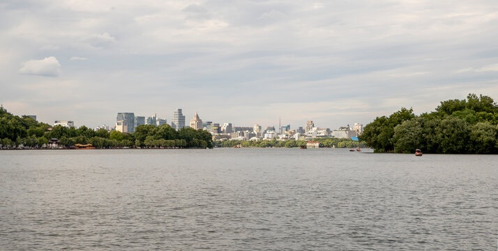 Wide West Lake panorama, with Hangzhou skyline and trees, China